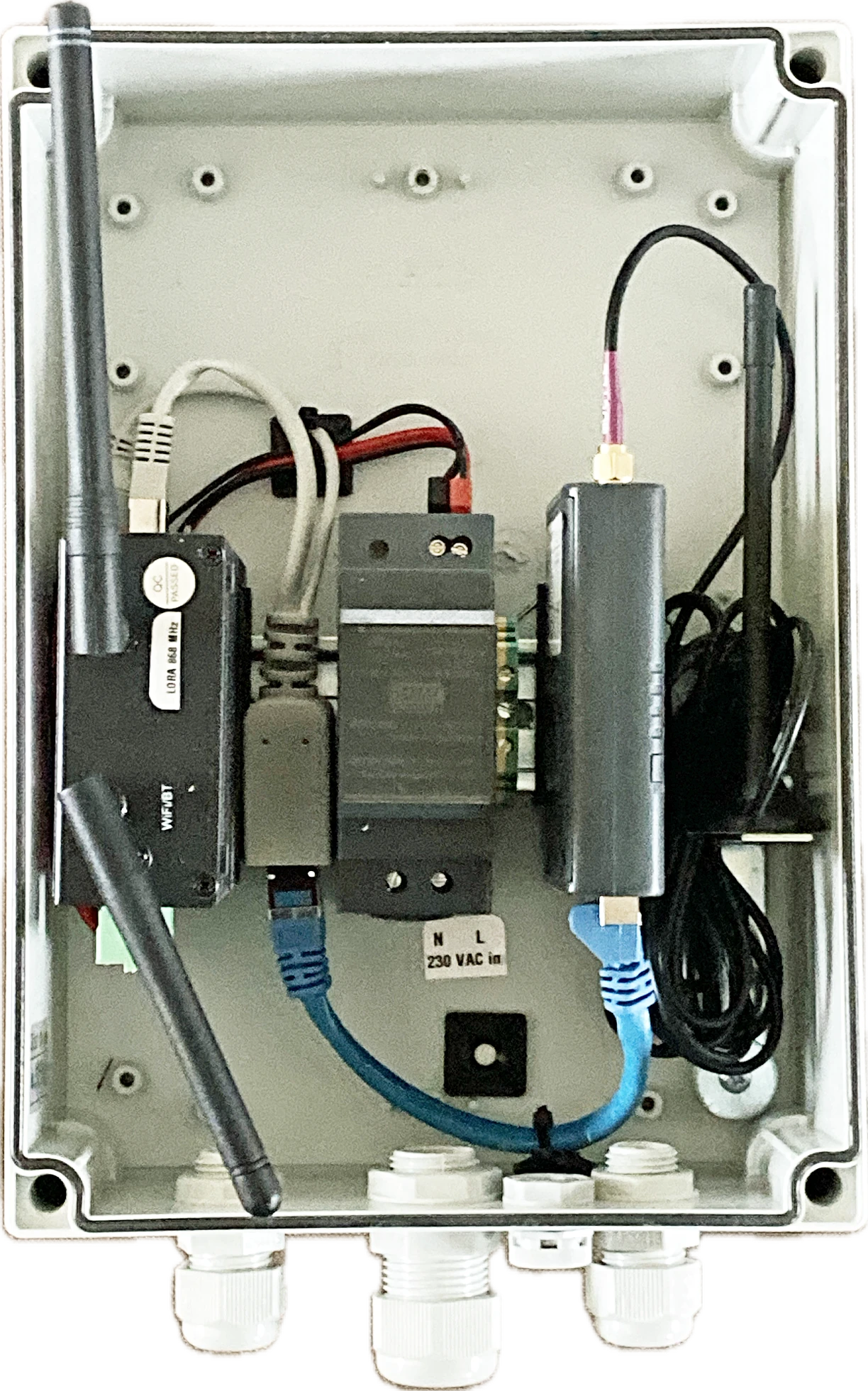 Open permanent enclosure with M4 on the left, power supply in the middle and cellular router on the right